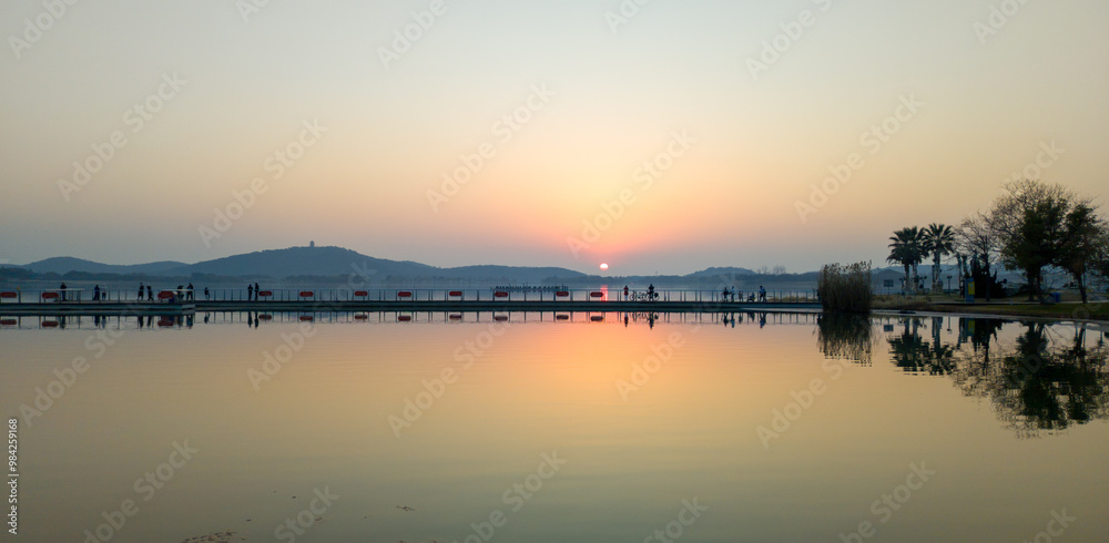 Serene Sunset Reflection Over Calm Waters in a Tranquil Landscape Serene Sunset Reflection Over Calm Waters in a Tranquil Landscape