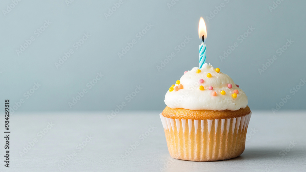 A delicious cupcake with single candle sits on plain table, evoking sense of celebration and joy. colorful sprinkles add festive touch to this sweet treat A delicious cupcake with single candle sits on plain table, evoking sense of celebration and joy. colorful sprinkles add festive touch to this sweet treat
