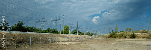 Εκτύπωση καμβά Empty dirt lot with overcast skies near train tracks, potentially depicting indu