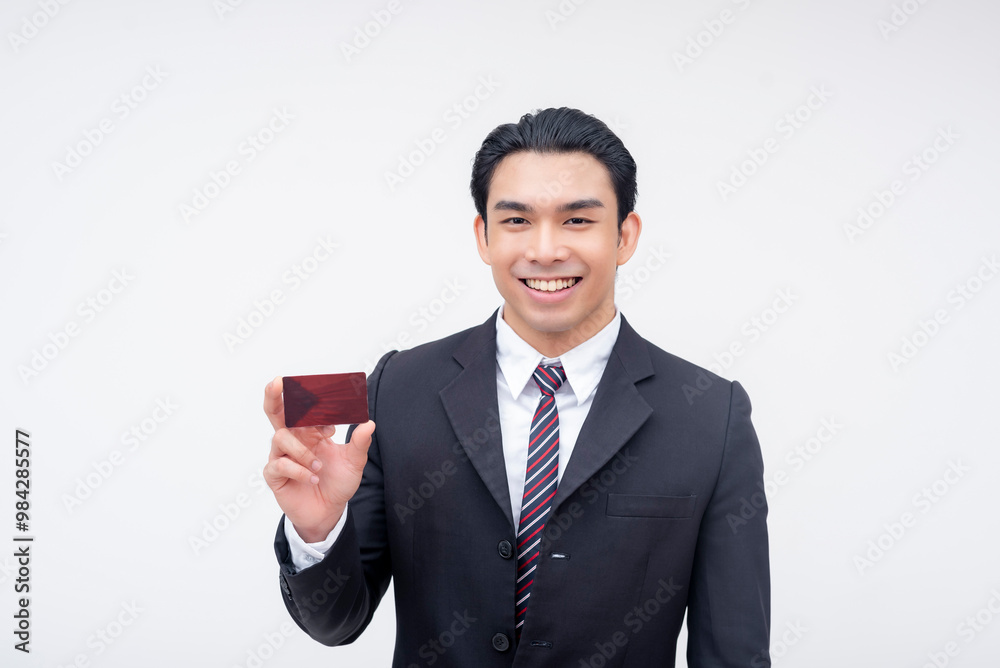 A confident young asian business executive smiling while presenting a blank card. Possible reward, membership or debit card. Isolated on a white background. A confident young asian business executive smiling while presenting a blank card. Possible reward, membership or debit card. Isolated on a white background.