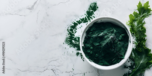 Green Spirulina Powder in White Bowl with Eucalyptus Leaves photo