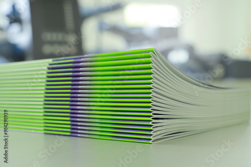 Stitched printing brochures folder in the bookbindery or print shop. Print sorted with spine. Lettershop or bookbinder.