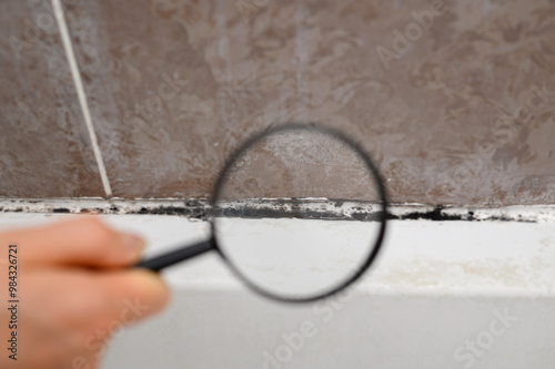 Fotografía Study of mold under magnifying glass in bathroom on tiles and sealant