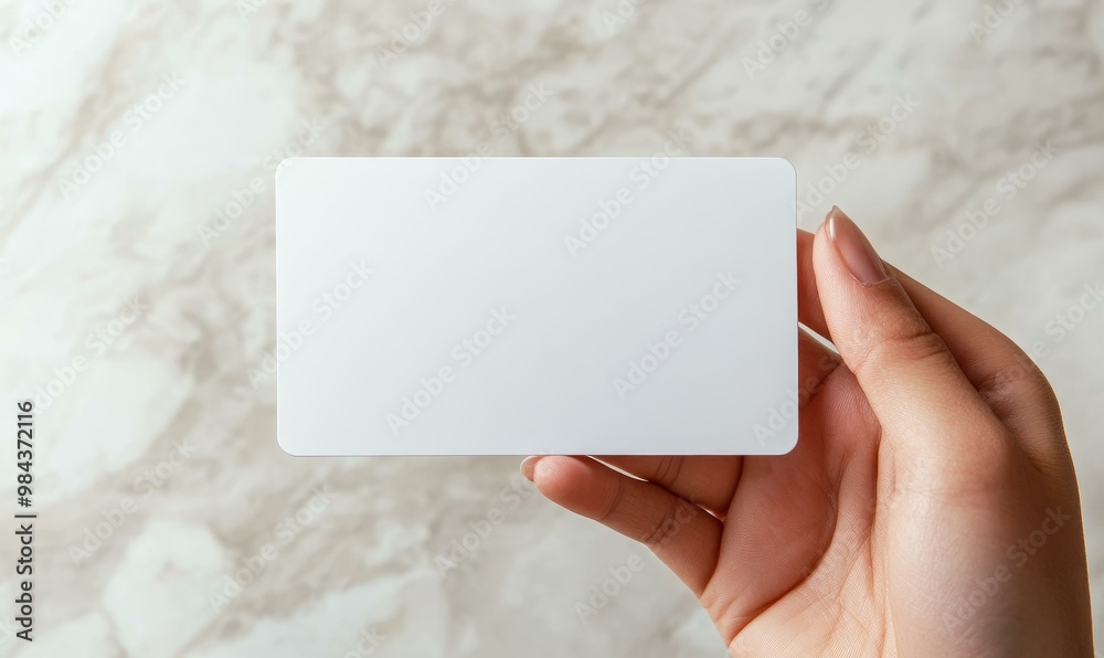 A hand holding a blank white card. A hand holding a blank white card.