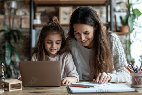 Mom and her teenage daughter are doing online lessons on a laptop at home during a remote lesson.