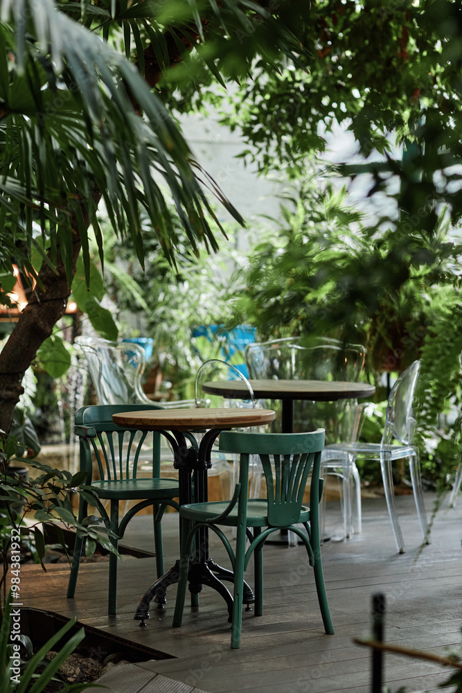 Fototapeta premium Vertical shot of wooden and plastic modern furniture in eco cafe with plants inside