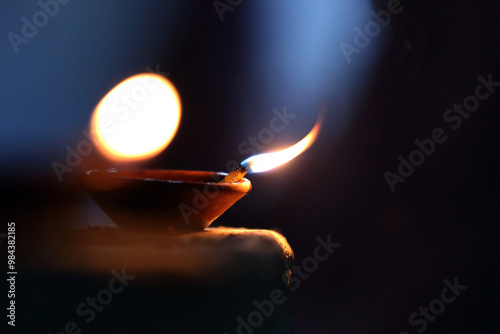 A radiant Diwali diya flickers brightly, symbolizing hope, joy, and the triumph of light over darkness. photo