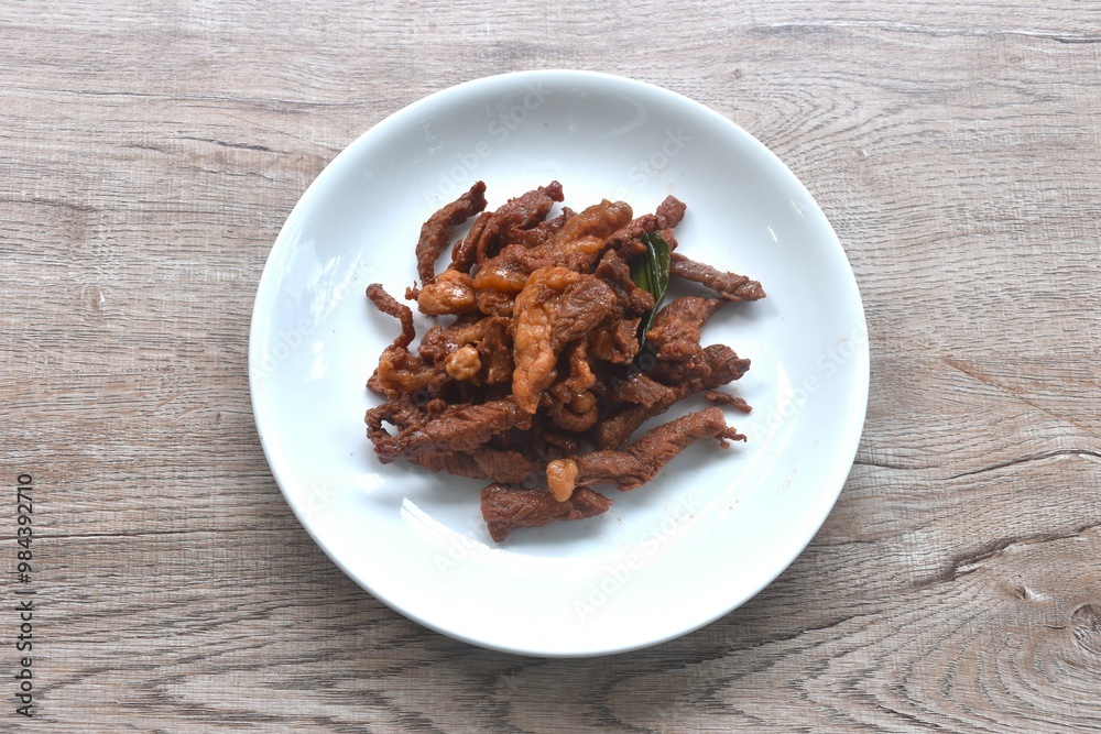 fried crispy salty fermenting beef meat with pandan and herb on plate fried crispy salty fermenting beef meat with pandan and herb on plate