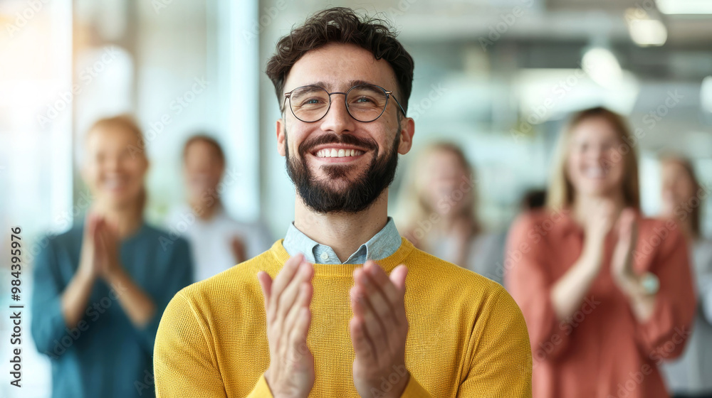 Colleagues applauding each other, large glass windows, open workspace, natural lighting, team victory, business achievement