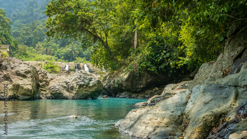 beautiful and exotic river views with clear blue water and large rocky hills, with a backdrop of tropical forests and water dams left over from the ancient Dutch era in Indonesia