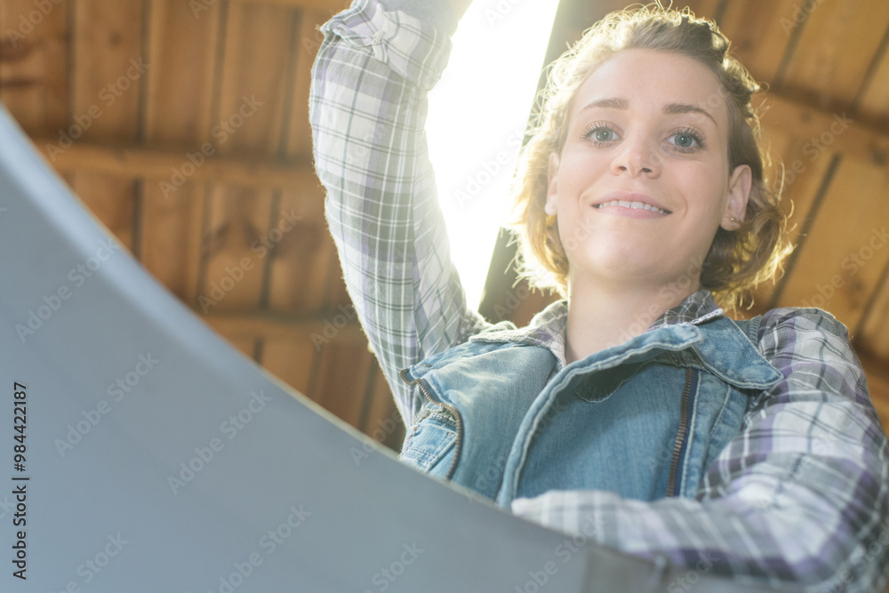 happy female carpenter working in workshop happy female carpenter working in workshop