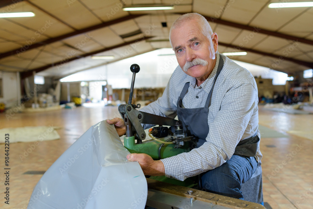 senior cutter working in furniture factory senior cutter working in furniture factory