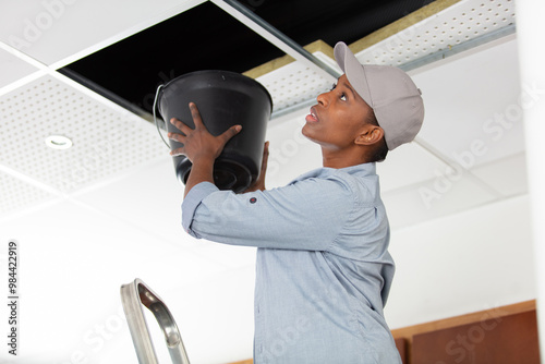 brunette woman dealing with water damage indoors photo