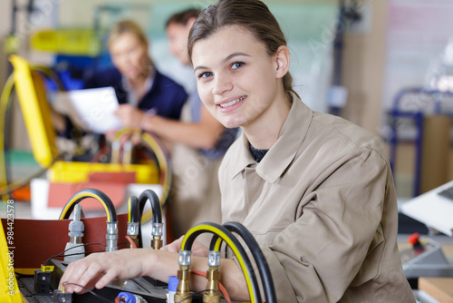 portrait of young female electrician in training