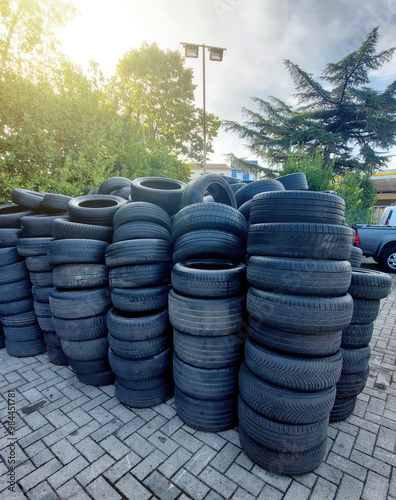 Pile of old tires waiting for recycling in a junkyard photo