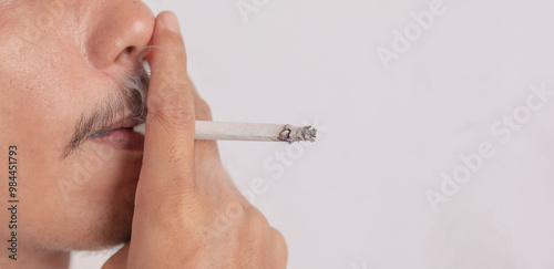 close-up photo of a person smoking a cigarette on a white background. health concept of cigarette smoke.