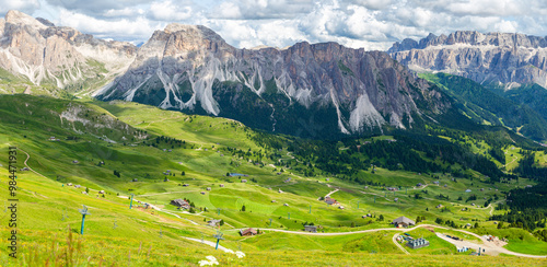 panoramic view of rocky mountain and blanket-like grass covered valley in summer, Seceda, Dolomites, Italy