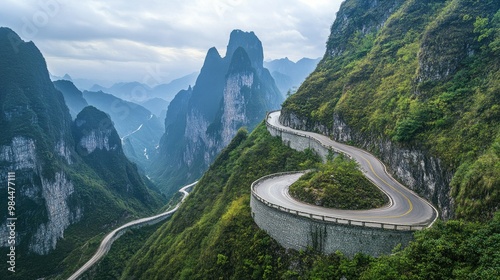 A panoramic view of the road winding up Tianmen Mountain towards HeavenGate, with sharp hairpin turns and steep cliffs on either side.