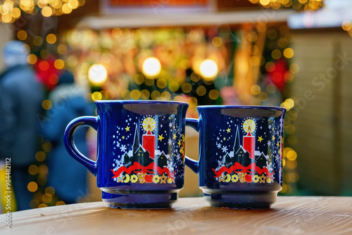 Obraz na płótnie Two glasses mugs with mulled wine or punch on Christmas Market in Germany. Traditional alcoholic drinks on German xmas funfair w salonie