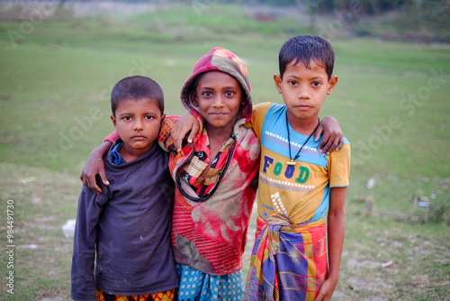 Portrait of rural boys standing near a river photo