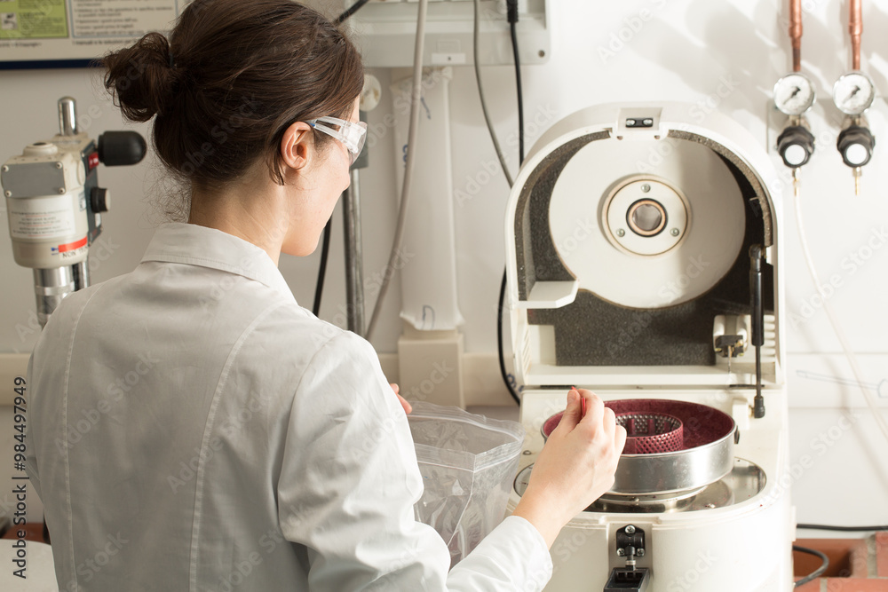 Scientist preparing sample for analysis using laboratory equipment Scientist preparing sample for analysis using laboratory equipment