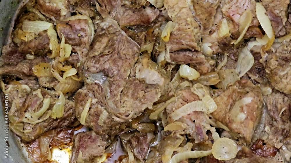 Pieces of roasted chopped meat beefsteak cooked with ghee with onion slices, salt and black pepper, bay laurel and cardamom, beef pieces, meat recipe done the Egyptian way, selective focus Pieces of roasted chopped meat beefsteak cooked with ghee with onion slices, salt and black pepper, bay laurel and cardamom, beef pieces, meat recipe done the Egyptian way, selective focus