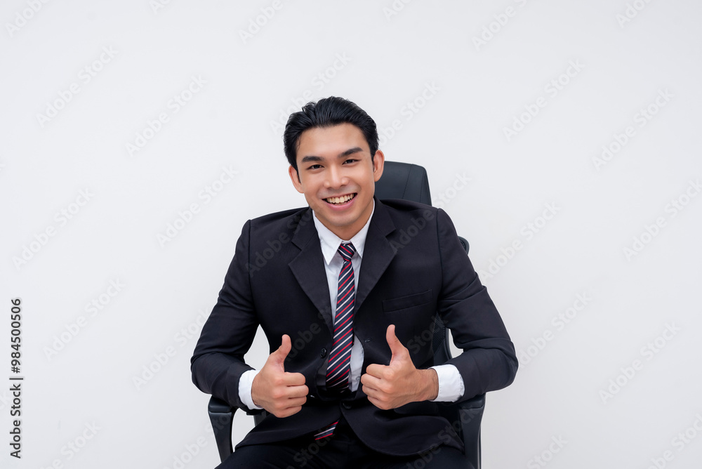 A young confident asian business executive sitting on an office chair, leaning forward and giving two thumbs up. Isolated on a white background. A young confident asian business executive sitting on an office chair, leaning forward and giving two thumbs up. Isolated on a white background.