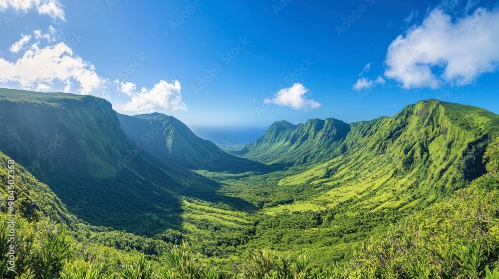 Fototapeta premium A panoramic view of Ackmon National Park lush green valleys surrounded by towering mountains under a clear blue sky.