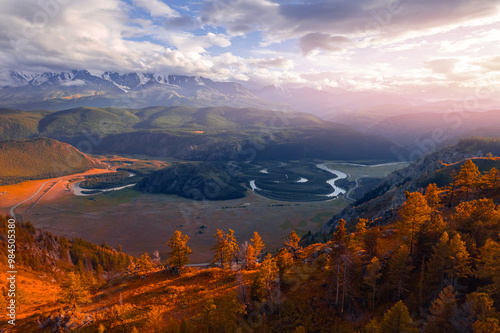 Beautiful aerial autumn landscape winding river meander in mountains with forest trees with sunlight, Altai Russia, top view