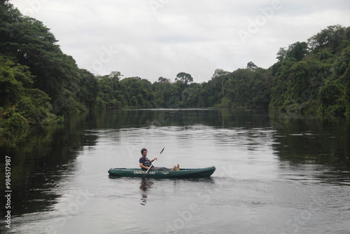 homem em caiaque no rio cristalino em alta floresta, mato grosso 