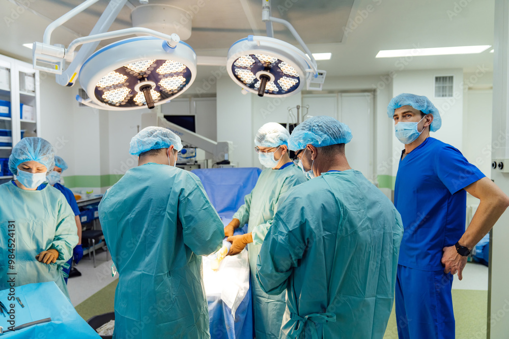 Surgical team in modern operating room. A dedicated surgical team conducts a procedure with precision in a well-equipped operating room during daylight hours. Surgical team in modern operating room. A dedicated surgical team conducts a procedure with precision in a well-equipped operating room during daylight hours.
