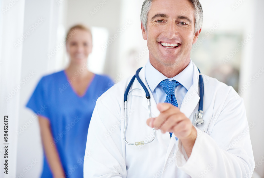 Portrait, happy man or doctor in hospital pointing at you with confidence for health insurance, choice and medical advice. Trust, support and mature healthcare professional with help, team and smile Portrait, happy man or doctor in hospital pointing at you with confidence for health insurance, choice and medical advice. Trust, support and mature healthcare professional with help, team and smile