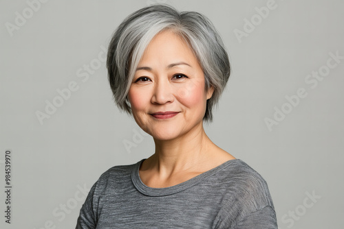 Middle Aged Asian Woman Portrait with Wrinkled Face and Deep Emotions, Wearing a Casual Clothes on a Neutral Background - Ideal for Lifestyle and Emotion Themed Stock Photography