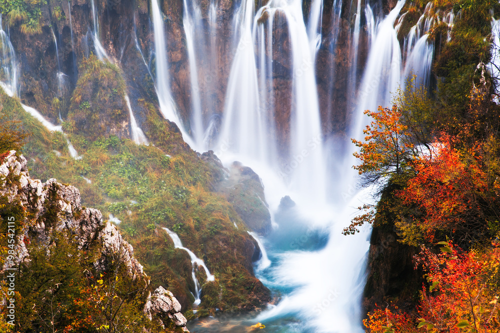 Scenic Autumn Waterfall in Serene Forest Setting