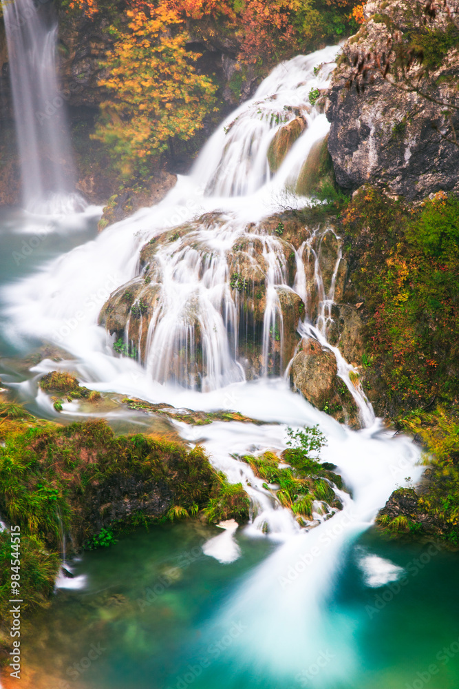 Scenic Autumn Waterfall in Serene Forest Setting
