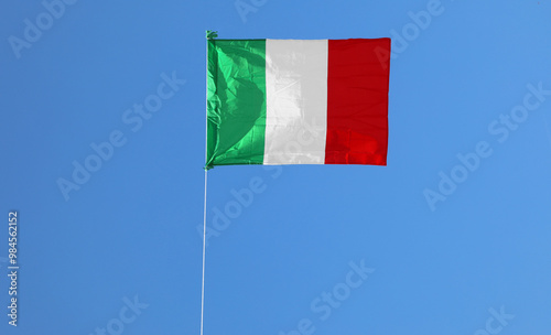 Obraz na plátně very large Italian flag on a blue background that is waving with the green white