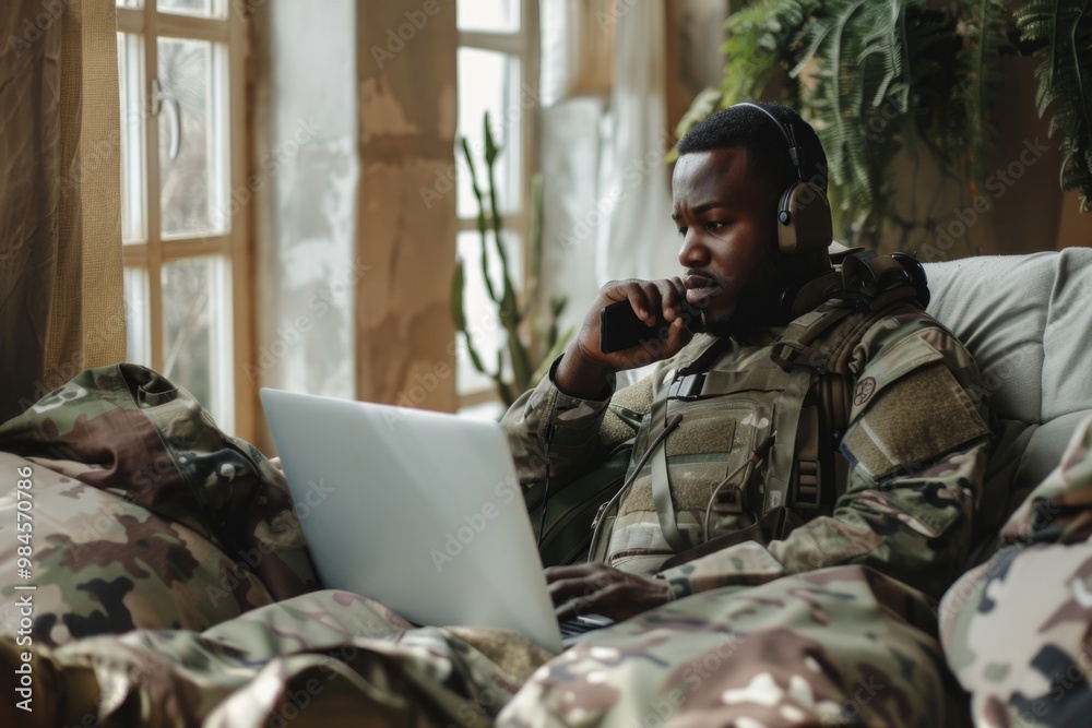 Fototapeta premium A person sitting on a couch with a laptop computer, possibly working or studying