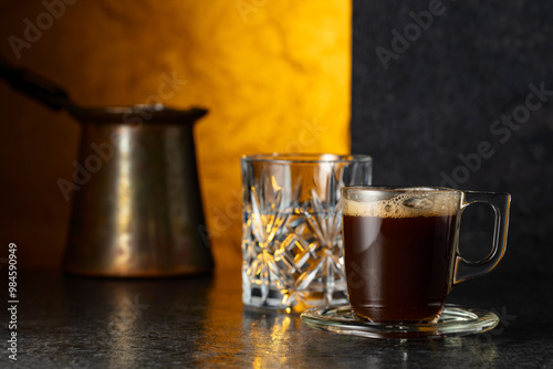 Espresso and glass of cold water on a black background.