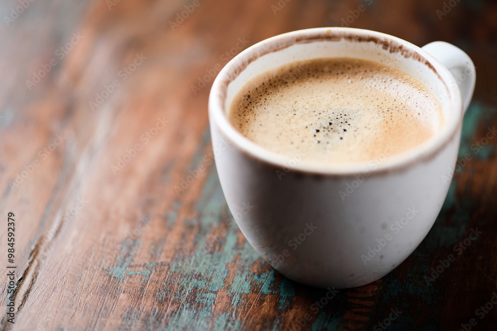 Cup of coffee on wooden background. Close up. Cup of coffee on wooden background. Close up.
