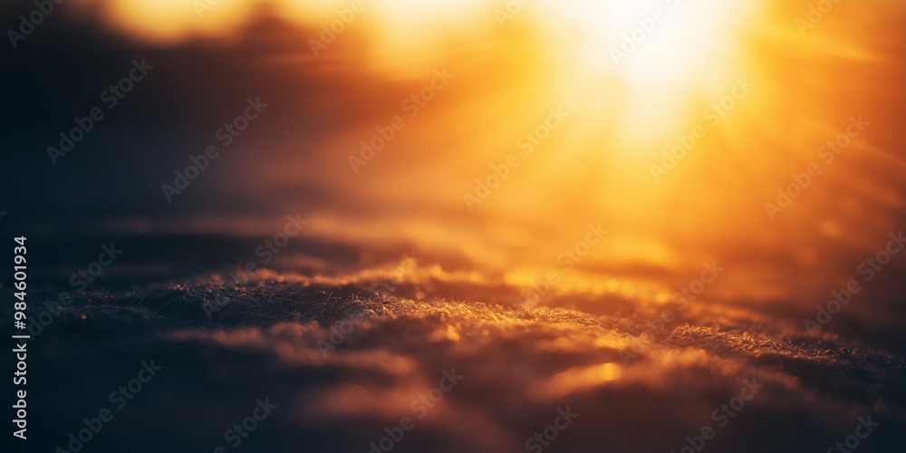 Fototapeta premium A beautiful sunset casting warm tones across a serene landscape, highlighting the subtle textures of the terrain.