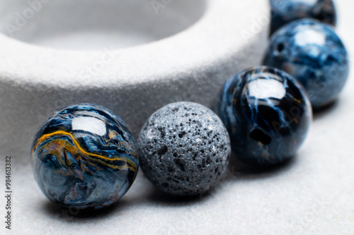 Close up of spherical stone beads making bracelet on jewelry making table. Selective soft focus