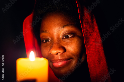 Keep Your Lamps Burning.A young woman holding a candle in the dark