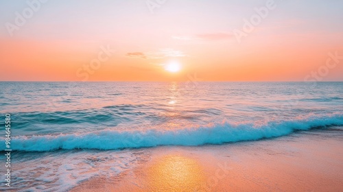 A serene sunset over the ocean, casting warm colors on the water and shoreline.