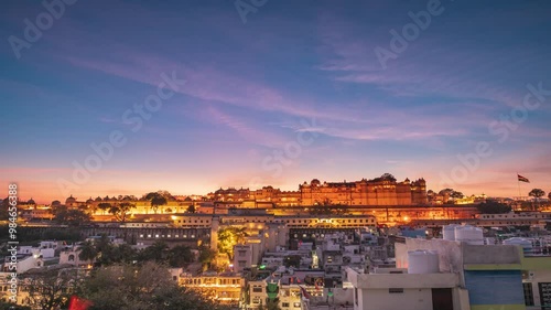 Time lapse: the city palace glowing at sunset in udaipur, india, with its massive structure towering over the city below. India, Rajasthan