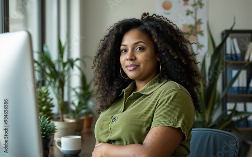 generation z graphic designer holds stomach while sitting, employee engagement at the workplace, corduroy polo shirt, well-chosen and lively balance with simplicity, houseplants, binders, portrait