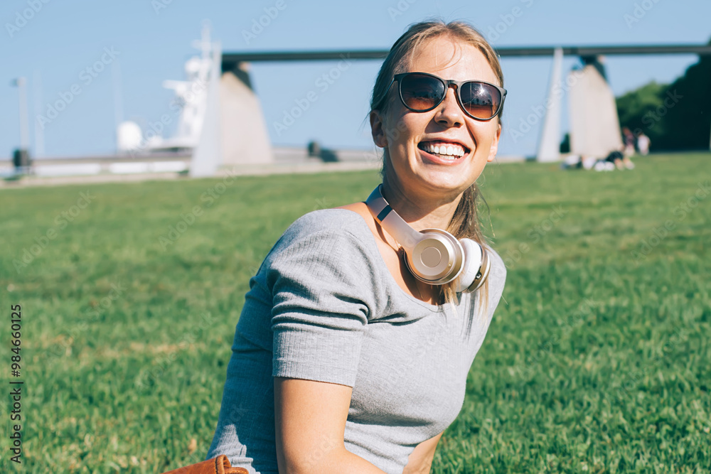 Fototapeta premium Charming modern woman on park meadow in sunlight