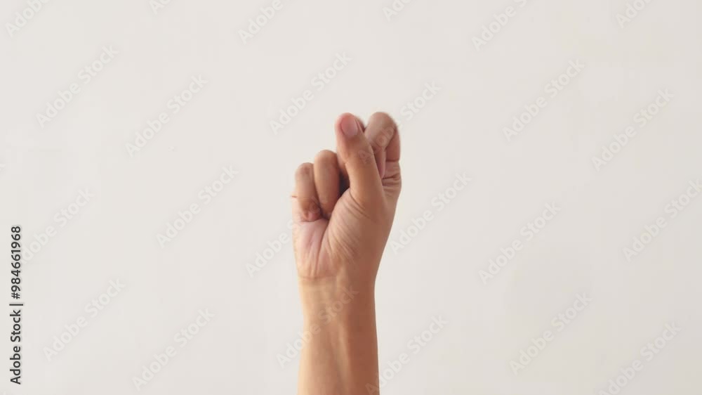 Woman's hands counting the numbers one to five on a white background. The hand of an adult asian woman shows the numbers one to five on a white background. 4K slow motion footage.