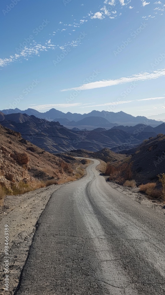 Fototapeta premium Winding Dirt Road Through Dramatic Desert Mountain Landscape
