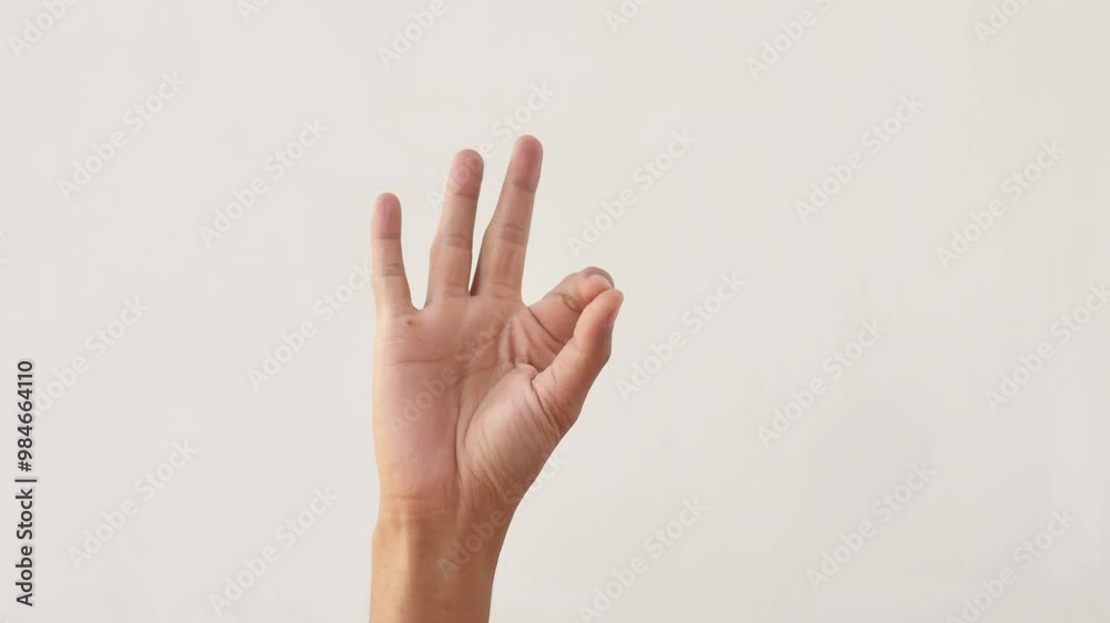 Asian hand showing OK. Asian male hand raised and showing an OK gesture on white isolated background. 4k footage deaf hand. Asian hand showing OK. Asian male hand raised and showing an OK gesture on white isolated background. 4k footage deaf hand.