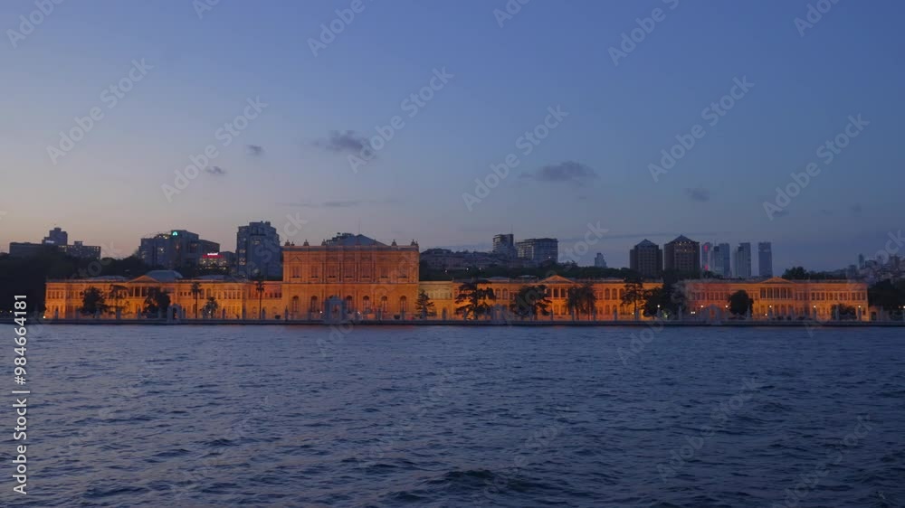 Dolmabahce Palace in Istanbul, Turkey seen from the Bosphorus Strait at Sunset. Skyscrapers of Modern Istanbul in the background. Concept of Bosphorus Tour, Cruise, Sightseeing, Travel, Skyline Dolmabahce Palace in Istanbul, Turkey seen from the Bosphorus Strait at Sunset. Skyscrapers of Modern Istanbul in the background. Concept of Bosphorus Tour, Cruise, Sightseeing, Travel, Skyline